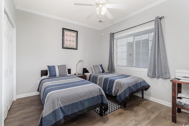 bedroom featuring crown molding, baseboards, and wood finished floors