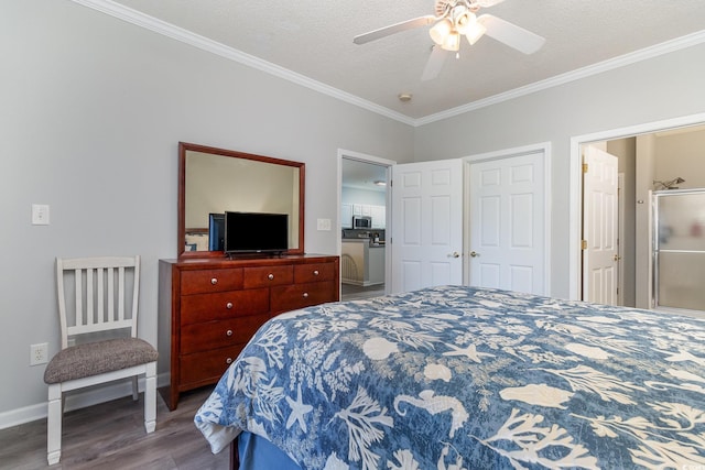 bedroom with a textured ceiling, baseboards, wood finished floors, and crown molding