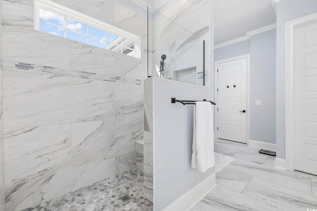 bathroom featuring crown molding and a tile shower