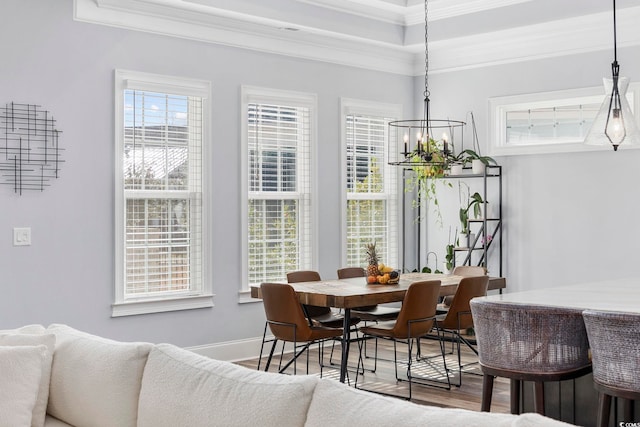 dining area featuring crown molding, a chandelier, and hardwood / wood-style flooring