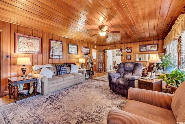 living area featuring wood ceiling, a ceiling fan, and wood finished floors