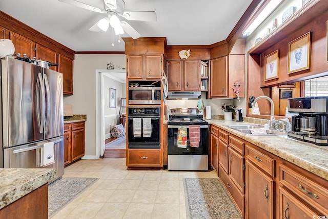 kitchen featuring under cabinet range hood, stainless steel appliances, a sink, light countertops, and crown molding