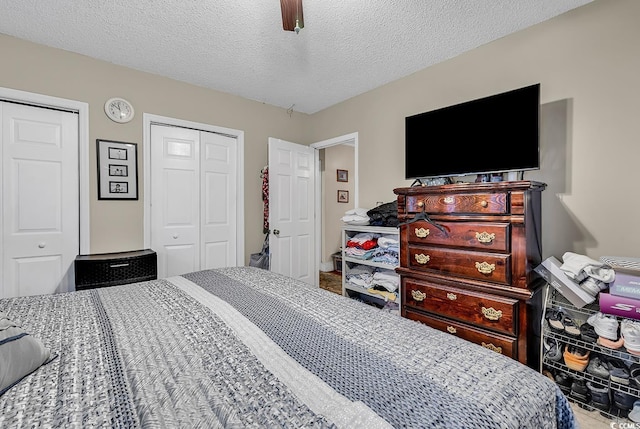 bedroom with a ceiling fan and a textured ceiling