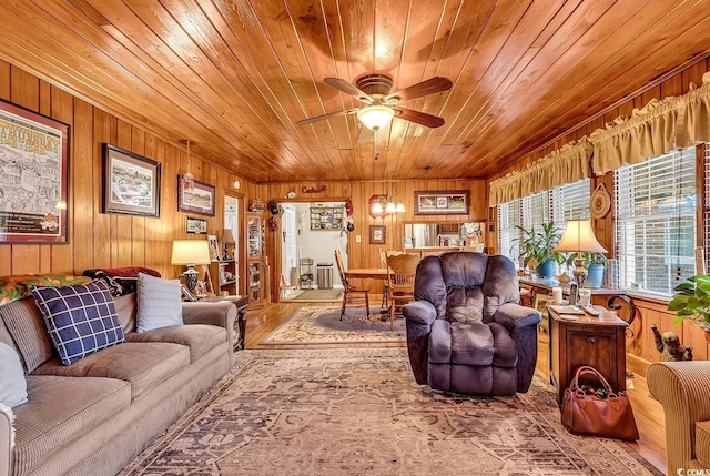 living room with a ceiling fan, wooden ceiling, wood walls, and wood finished floors