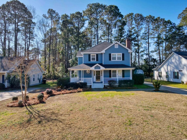 view of front facade with a front yard and covered porch