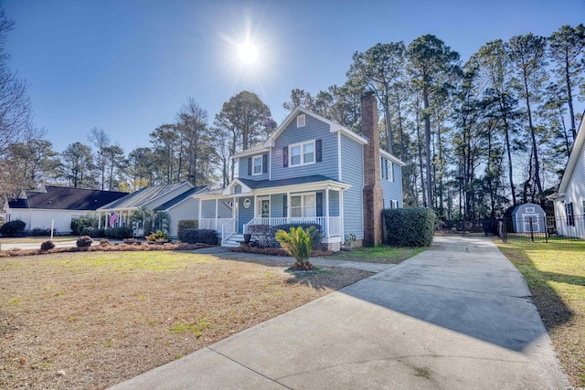 front of property featuring a front lawn and covered porch