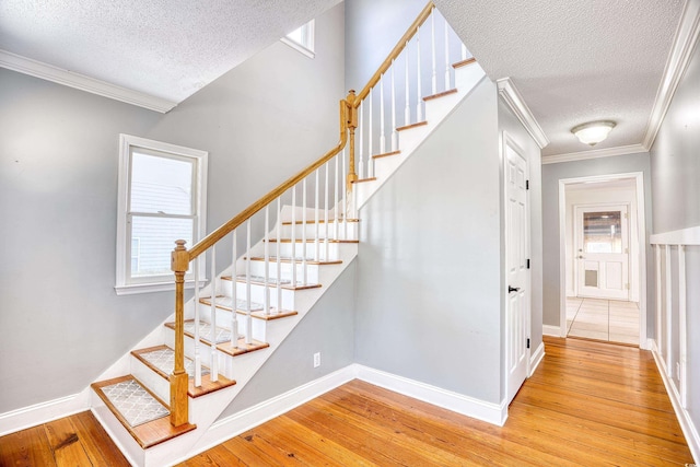 116 Great Lakes Rd, Pawleys Island, SC 29585 - stairs featuring hardwood / wood-style floors, ornamental molding, and a textured ceiling