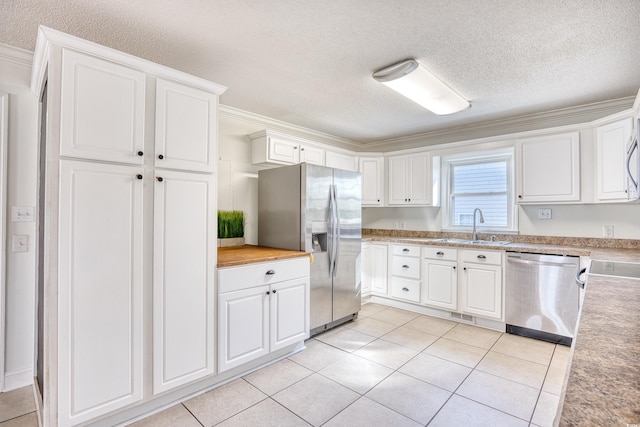 116 Great Lakes Rd, Pawleys Island, SC 29585 - kitchen featuring ornamental molding, light tile patterned flooring, white cabinets, and appliances with stainless steel finishes