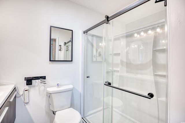 116 Great Lakes Rd, Pawleys Island, SC 29585 - bathroom with vanity, toilet, an enclosed shower, and a textured ceiling