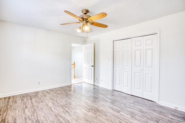 116 Great Lakes Rd, Pawleys Island, SC 29585 - unfurnished bedroom featuring ceiling fan, light hardwood / wood-style floors, a closet, and a textured ceiling