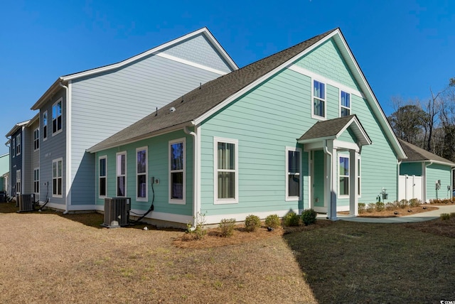 exterior space with a lawn and central air condition unit