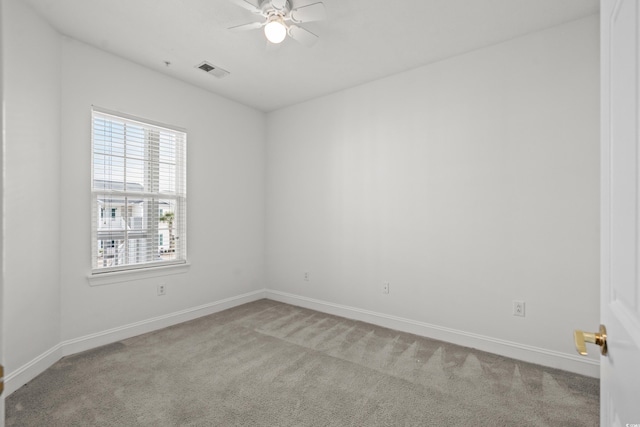 empty room featuring light colored carpet and ceiling fan