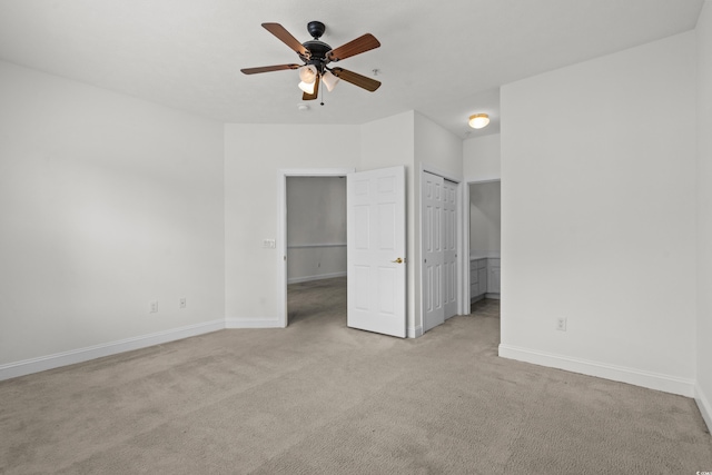 unfurnished bedroom featuring light colored carpet and ceiling fan