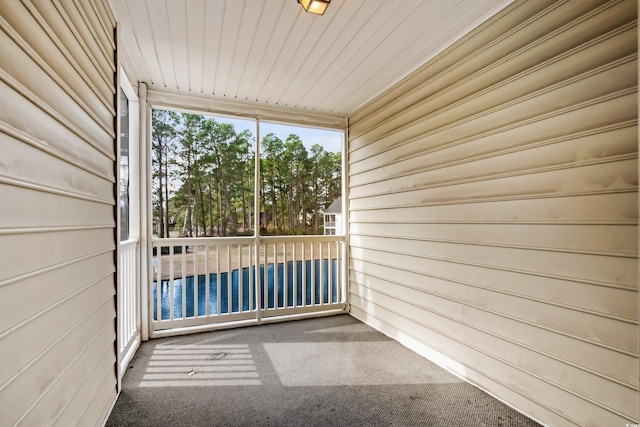 unfurnished sunroom featuring wooden ceiling