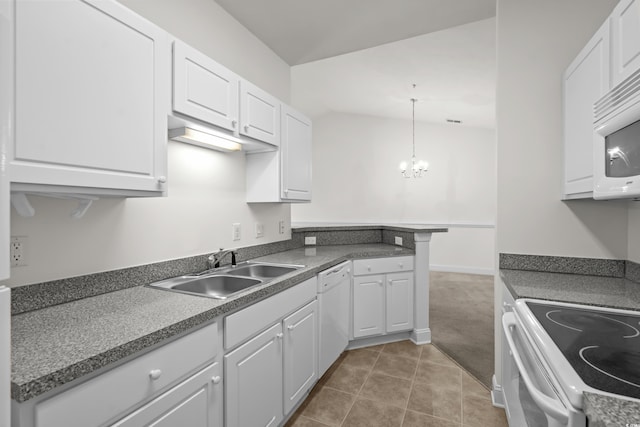 kitchen with pendant lighting, sink, white appliances, and white cabinets