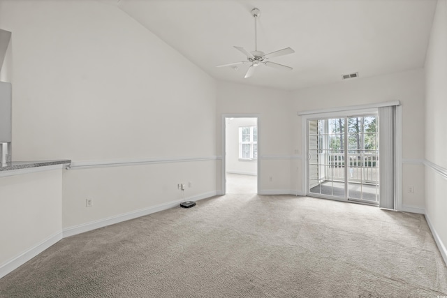 empty room with ceiling fan, light colored carpet, and lofted ceiling