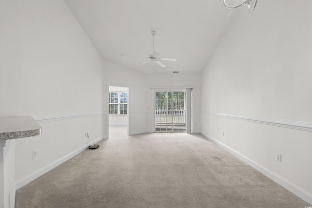 unfurnished living room featuring ceiling fan, light colored carpet, and high vaulted ceiling