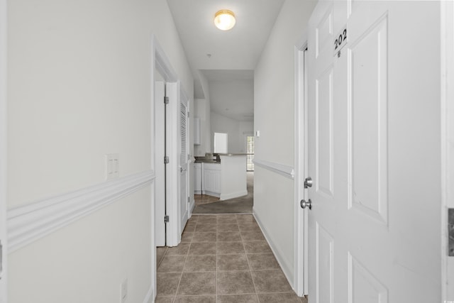 corridor featuring light tile patterned flooring