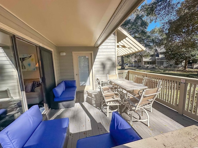 view of patio / terrace with outdoor dining area and a wooden deck