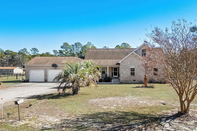 view of front of property featuring a garage and a front lawn