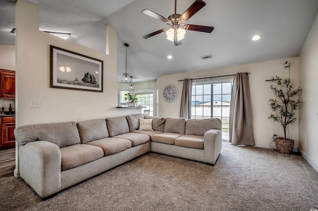 living room with vaulted ceiling, carpet, and ceiling fan