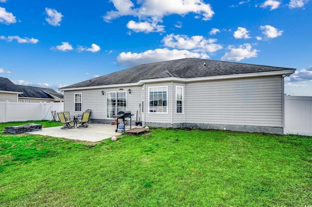 back of house with a patio, an outdoor fire pit, and a lawn