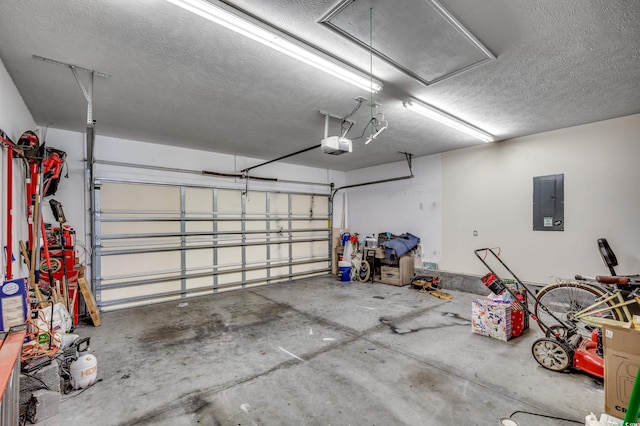 garage with a garage door opener and electric panel