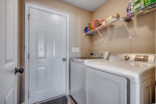 clothes washing area with separate washer and dryer