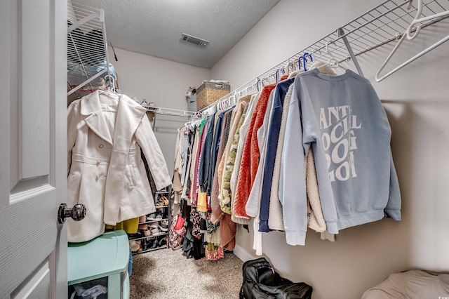 walk in closet featuring carpet flooring