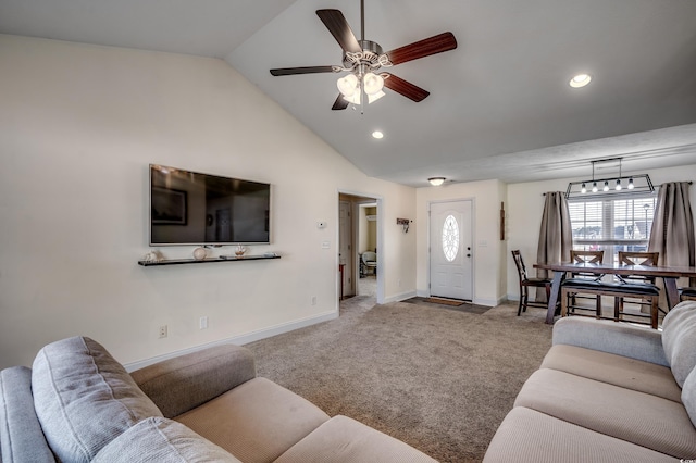 living room featuring vaulted ceiling, light carpet, and ceiling fan