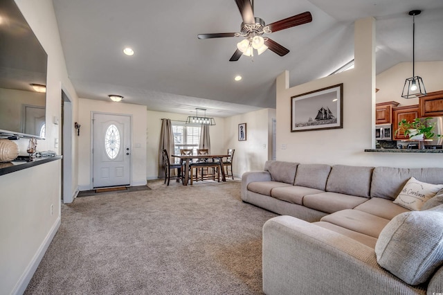 carpeted living room featuring high vaulted ceiling and ceiling fan