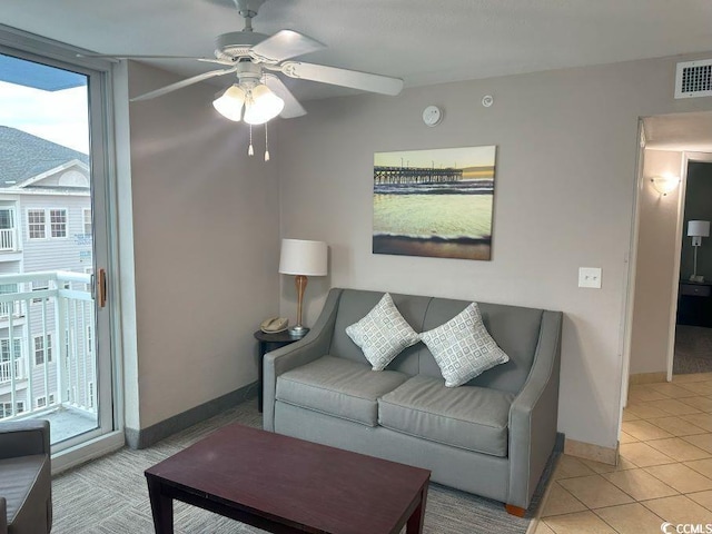 living room with ceiling fan and light tile patterned flooring