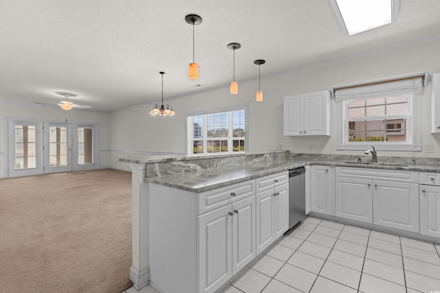 kitchen with pendant lighting, white cabinetry, sink, stainless steel dishwasher, and kitchen peninsula