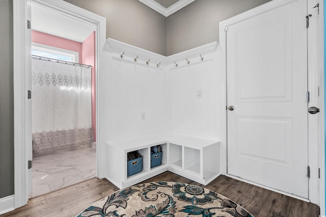 mudroom featuring wood-type flooring and ornamental molding