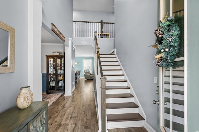 foyer featuring ornamental molding and hardwood / wood-style floors