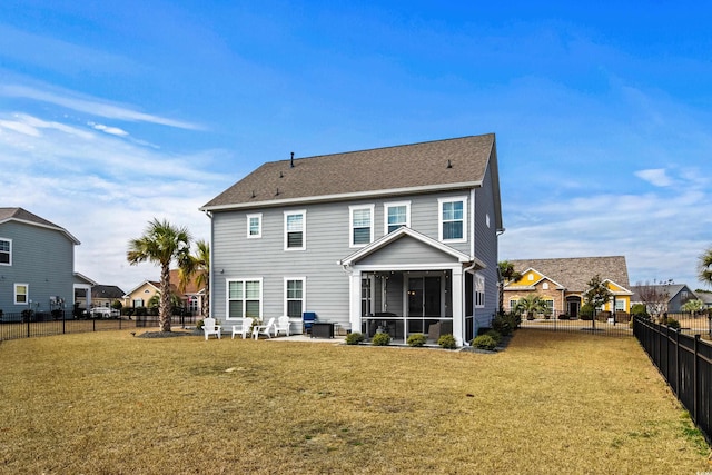 back of house featuring a sunroom, a patio, and a lawn