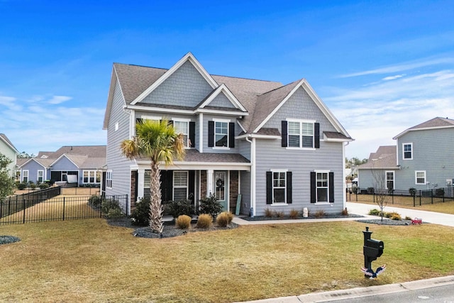 view of front of property featuring a front yard and covered porch