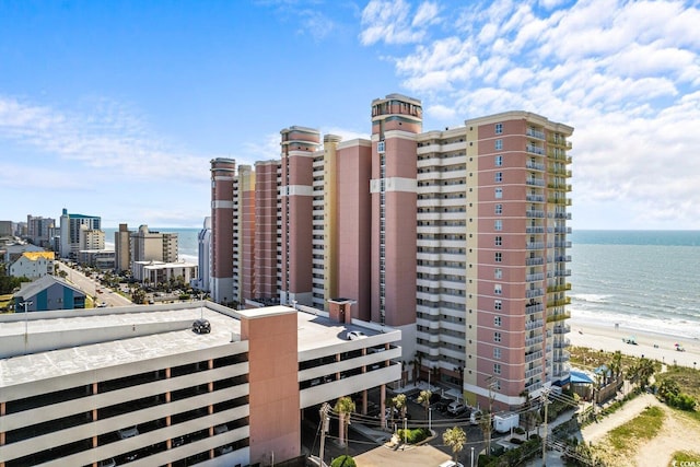 view of property featuring a beach view and a water view