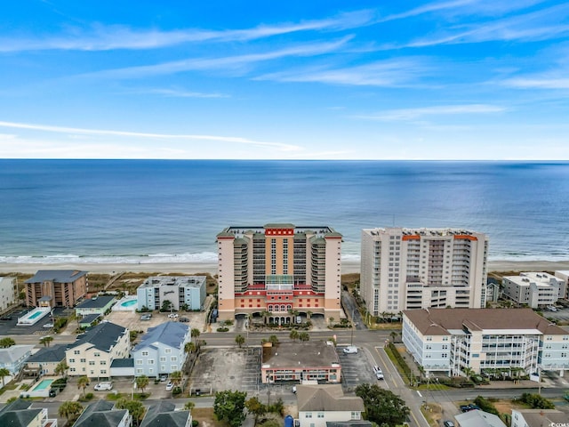 drone / aerial view with a water view and a beach view