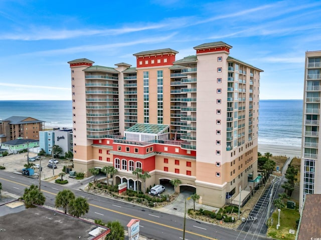 view of property featuring a water view and a view of the beach