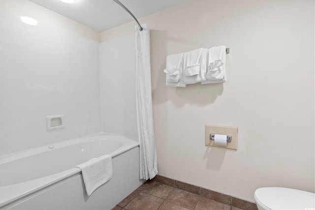 bathroom with tile patterned floors, toilet, and shower / bath combo