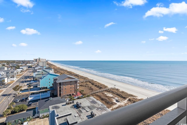 drone / aerial view featuring a water view and a beach view