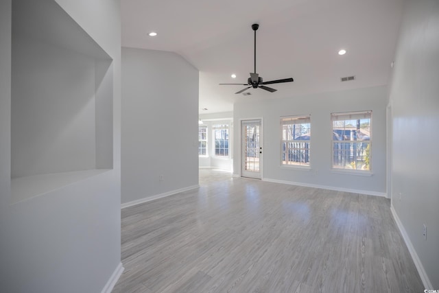 unfurnished living room with light wood-style flooring, visible vents, and baseboards