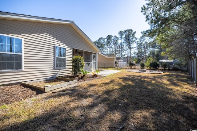 view of yard with a patio area, ceiling fan, a sunroom, and a fenced backyard