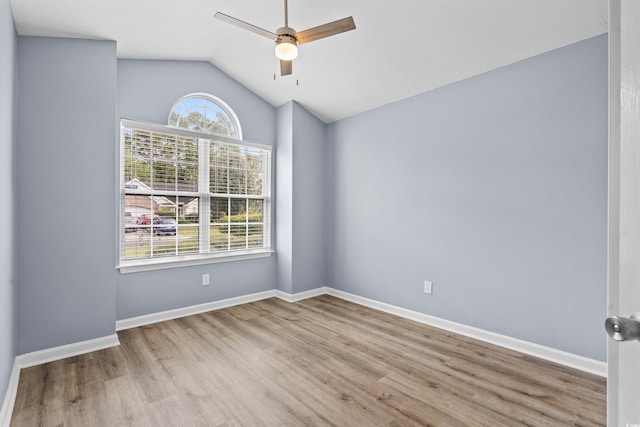 unfurnished room featuring light hardwood / wood-style flooring, a wealth of natural light, ceiling fan, and vaulted ceiling