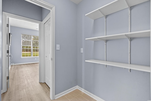 walk in closet with light wood-type flooring