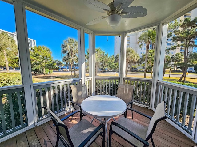 sunroom with a wealth of natural light and ceiling fan