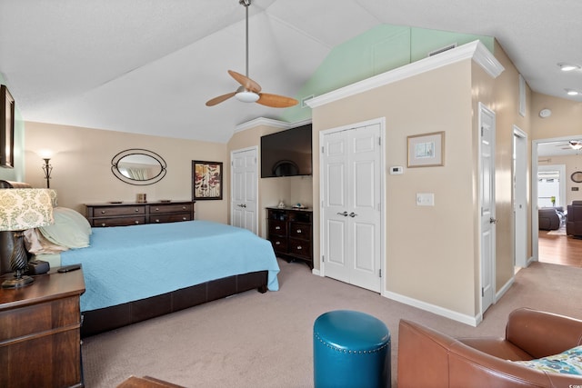 carpeted bedroom featuring lofted ceiling and ceiling fan