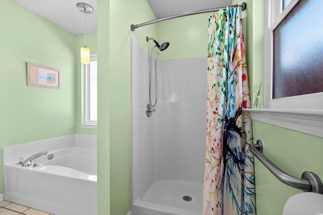 bathroom featuring plus walk in shower, tile patterned floors, and a textured ceiling