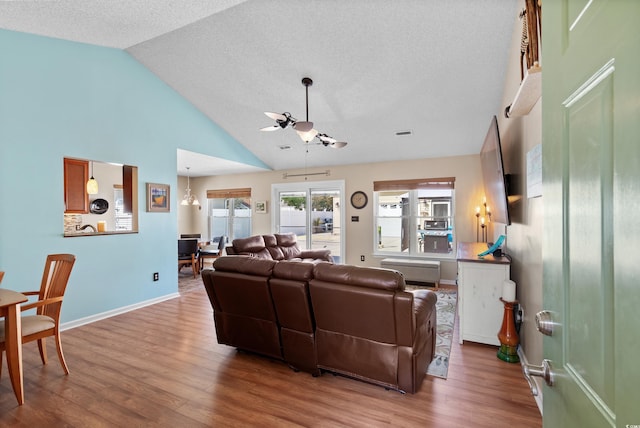 living room featuring high vaulted ceiling, hardwood / wood-style flooring, a textured ceiling, and ceiling fan